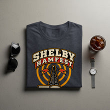 Load image into Gallery viewer, Dark gray t-shirt with "Shelby Hamfest" text and radio tower graphic.
