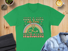 Load image into Gallery viewer, Green t-shirt with "Just a girl who loves nursing" text and rainbow stethoscope graphic.
