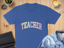 Load image into Gallery viewer, Blue t-shirt with "TEACHER" in pastel rainbow lettering.
