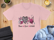 Load image into Gallery viewer, Pink t-shirt with "Peace Love Scrub" text and medical graphics.
