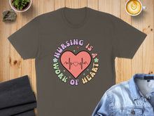 Load image into Gallery viewer, Brown t-shirt with "Nursing is a work of heart" text and a heart monitor design.
