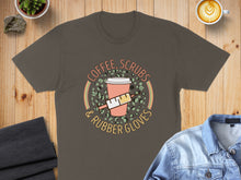 Load image into Gallery viewer, T-shirt with coffee, scrubs, and rubber gloves graphic.

