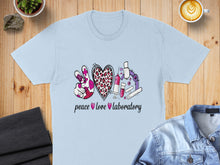 Load image into Gallery viewer, Light blue t-shirt with "peace love laboratory" and science graphics.
