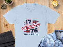 Load image into Gallery viewer, Light blue t-shirt with "1776 America Land of the Free" text.
