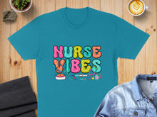 Load image into Gallery viewer, Teal t-shirt with colorful "Nurse Vibes" text and medical icons.
