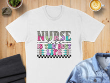 Load image into Gallery viewer, White t-shirt with "Nurse is the best life" text and medical syringe graphic.
