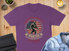 Load image into Gallery viewer, Purple t-shirt with Sasquatch silhouette, American flag, and "4th July Semiquincentennial 1776-2026".
