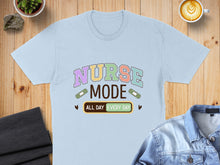 Load image into Gallery viewer, Light blue t-shirt with "Nurse Mode All Day Every Day" text and band-aid graphics.
