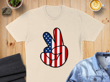 Load image into Gallery viewer, Cream t-shirt with a peace sign design featuring American flag stripes.
