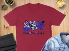 Load image into Gallery viewer, Burgundy t-shirt with leopard print peace sign, teeth, and coffee cup graphic reading "Peace love dental".
