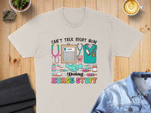 Load image into Gallery viewer, Nurse shirt with "Can't talk right now doing nurse stuff" text and medical icons.
