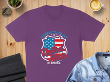 Load image into Gallery viewer, Purple t-shirt with Independence Day, American flag shield, and "United States of America" text.
