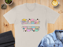 Load image into Gallery viewer, Beige t-shirt with colorful pencil graphics and a split design.
