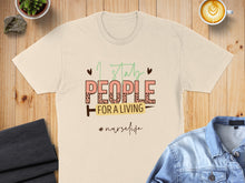 Load image into Gallery viewer, Cream t-shirt with "I stab people for a living #nurselife" text.
