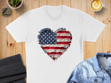Load image into Gallery viewer, White t-shirt with distressed American flag heart graphic, styled flat lay.
