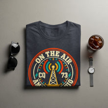 Load image into Gallery viewer, Dark gray t-shirt with "On The Air CQ 73 Amateur Radio" graphic and transmission tower.
