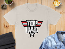 Load image into Gallery viewer, Beige t-shirt with distressed "TOP DAD" logo in red, white, and blue.
