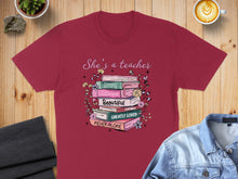 Load image into Gallery viewer, Teacher t-shirt with stacked books and inspirational text.
