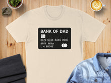 Load image into Gallery viewer, T-shirt with a credit card design reading "BANK OF DAD" and "I. M. BROKE".
