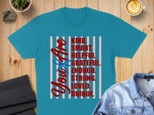 Load image into Gallery viewer, Teal t-shirt with "You Are Kind. Smart. Helpful. Grateful. Enough. Strong. Loved. Unique." text.
