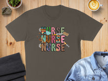 Load image into Gallery viewer, Brown t-shirt with "Nurse Nurse" text in colorful leopard print and checkerboard patterns.
