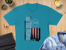 Load image into Gallery viewer, Teal t-shirt with "We the People" and distressed American flag graphic.

