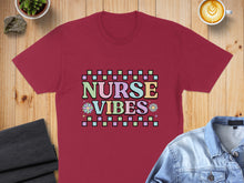 Load image into Gallery viewer, Burgundy t-shirt with "Nurse Vibes" in colorful pastel text.
