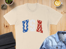 Load image into Gallery viewer, Cream t-shirt with distressed USA lettering in red, white, and blue.
