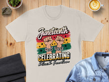 Load image into Gallery viewer, Juneteenth shirt celebrating Black freedom with raised fists and linked chains.
