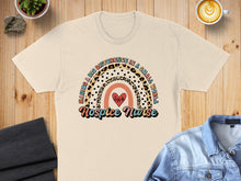 Load image into Gallery viewer, Cream t-shirt with rainbow and heart graphic; "Hospice Nurse" text.
