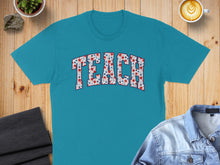 Load image into Gallery viewer, Teal t-shirt with "TEACH" in a floral pattern.

