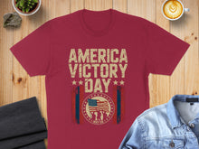 Load image into Gallery viewer, Maroon t-shirt with "America Victory Day May 08" and American flag graphic.
