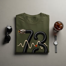 Load image into Gallery viewer, Olive green t-shirt with black 73 graphic, waveform, and red dot.
