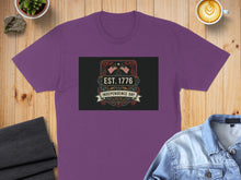 Load image into Gallery viewer, Purple t-shirt with "EST. 1776 INDEPENDENCE DAY" graphic and US flags.
