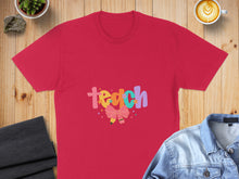 Load image into Gallery viewer, Red t-shirt with colorful "teach" text and a pink bow graphic.
