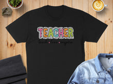 Load image into Gallery viewer, Black t-shirt with "TEACHER" in colorful leopard print and "teach love inspire" below.
