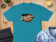 Load image into Gallery viewer, Turquoise t-shirt with distressed "America" text featuring American flag detail.
