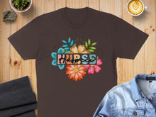 Load image into Gallery viewer, Brown t-shirt with colorful floral "Nurse" text design.
