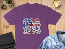 Load image into Gallery viewer, Purple t-shirt with "USA 1776" text in American flag pattern.
