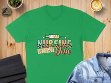 Load image into Gallery viewer, Green t-shirt with "Nursing is in my DNA" text and medical icons.
