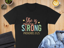 Load image into Gallery viewer, Black t-shirt with "She is STRONG" and "PROVERBS 31:25" text.

