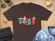 Load image into Gallery viewer, T-shirt with four coffee cups decorated with medical symbols like crosses and band-aids.
