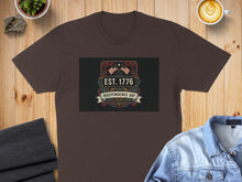 Load image into Gallery viewer, Brown t-shirt with "EST. 1776 Independence Day" graphic featuring American flags.
