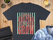 Load image into Gallery viewer, Dark grey t-shirt with red text "HELPING LITTLE MINDS GROW" on mint stripes.
