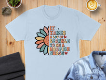 Load image into Gallery viewer, It takes a lot of sparkle to be a hospice nurse text with colorful flower.
