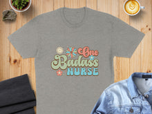 Load image into Gallery viewer, Grey t-shirt with "One Badass Nurse" text and floral graphics.
