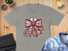 Load image into Gallery viewer, Gray t-shirt featuring a pink ribbon with XOXO pattern, stethoscope, and red cross.
