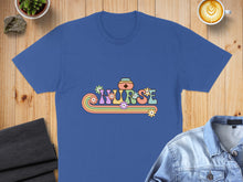 Load image into Gallery viewer, "Nurse" text with flowers and a cap on a blue t-shirt.
