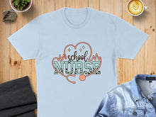 Load image into Gallery viewer, Light blue t-shirt with "school nurse" text and stethoscope.
