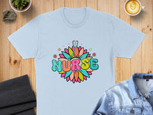 Load image into Gallery viewer, Light blue t-shirt with "NURSE" text in colorful floral design.
